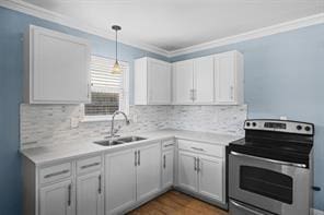 kitchen featuring white cabinetry, sink, backsplash, stainless steel range with electric cooktop, and ornamental molding