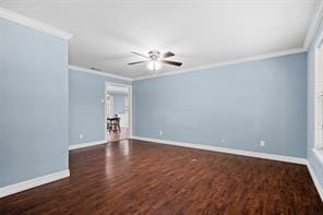 spare room featuring crown molding and dark hardwood / wood-style flooring