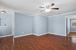 spare room featuring crown molding, ceiling fan, and dark hardwood / wood-style flooring