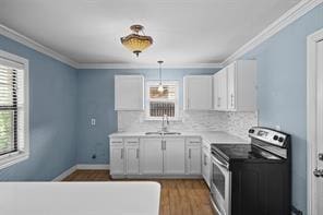 kitchen featuring crown molding, hanging light fixtures, stainless steel electric range, and white cabinets