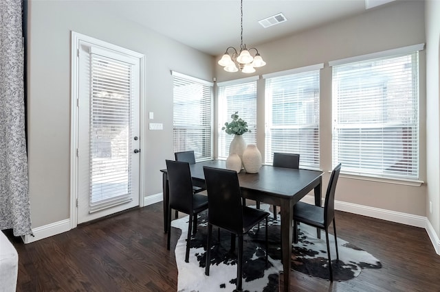 dining room featuring a notable chandelier and dark hardwood / wood-style floors