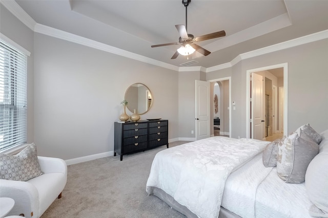 bedroom with light carpet, a tray ceiling, crown molding, and ceiling fan