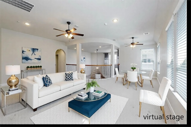 carpeted living room featuring ceiling fan