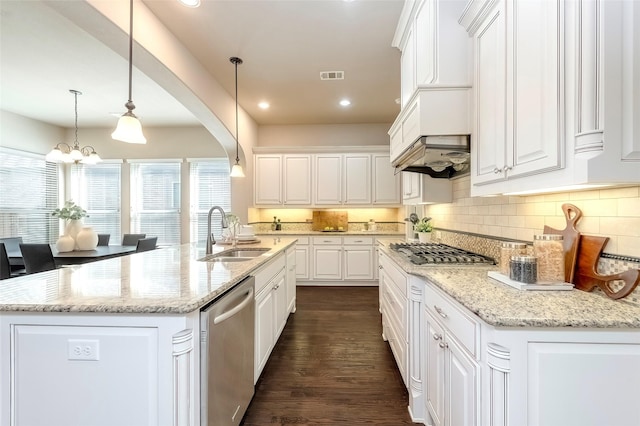 kitchen with white cabinetry, appliances with stainless steel finishes, and an island with sink