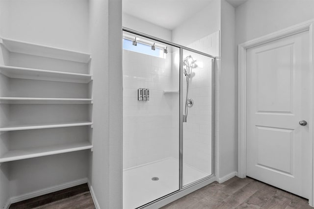 bathroom with walk in shower and wood-type flooring