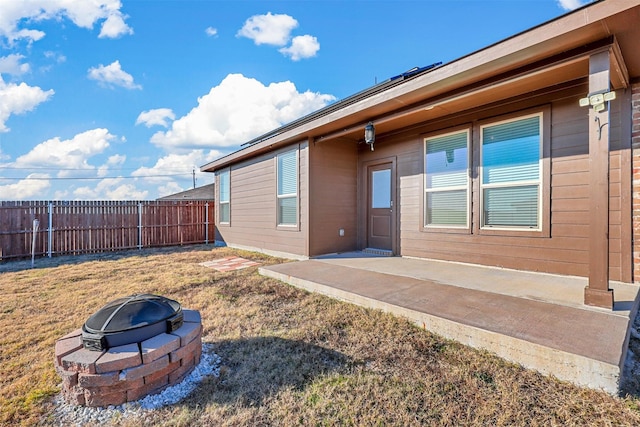 exterior space with a yard, a fire pit, and a patio area