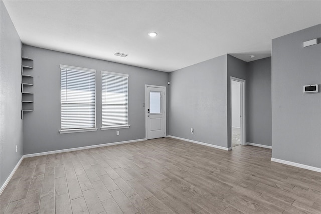 unfurnished room with light wood-type flooring