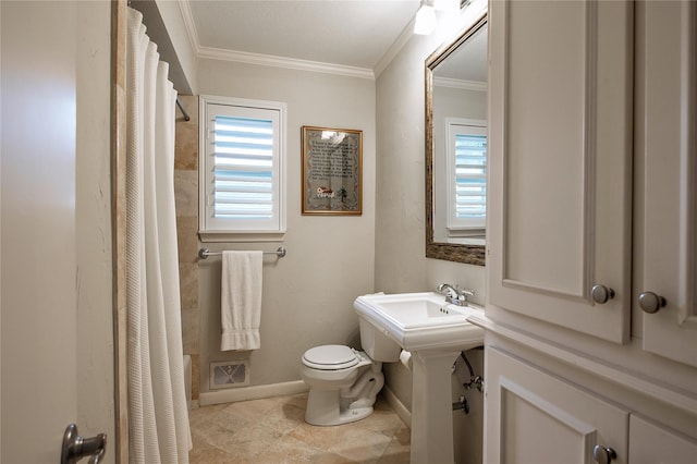 bathroom with ornamental molding, sink, and toilet