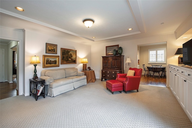 carpeted living room with ornamental molding