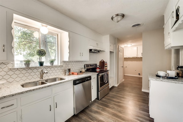 kitchen featuring dark wood-type flooring, sink, tasteful backsplash, stainless steel appliances, and white cabinets