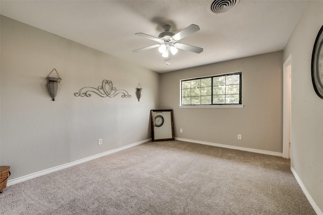 spare room featuring ceiling fan and carpet flooring