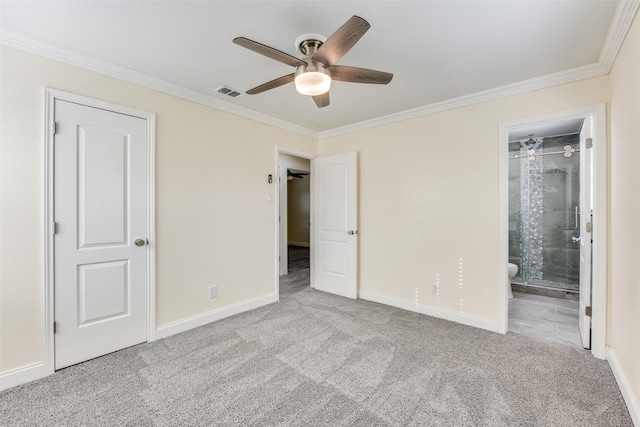 unfurnished bedroom with crown molding, connected bathroom, light colored carpet, and ceiling fan