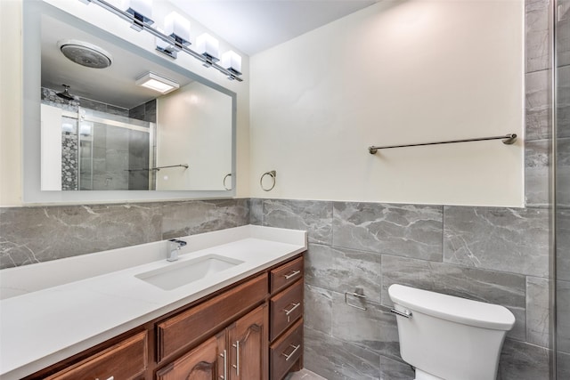 bathroom featuring vanity, tile walls, an enclosed shower, and toilet