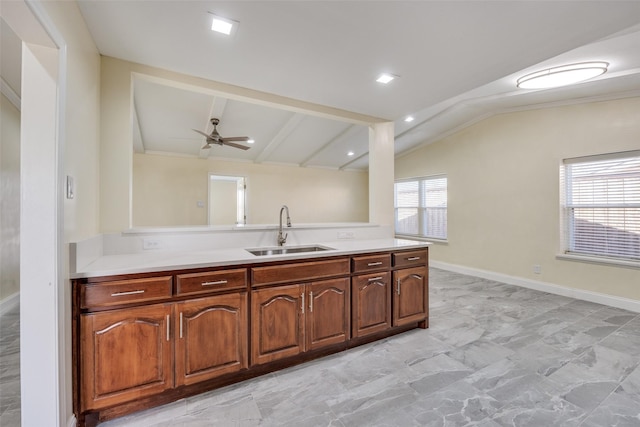 kitchen featuring ceiling fan, lofted ceiling, and sink