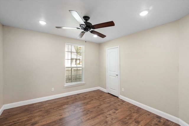 unfurnished room featuring dark wood-type flooring and ceiling fan