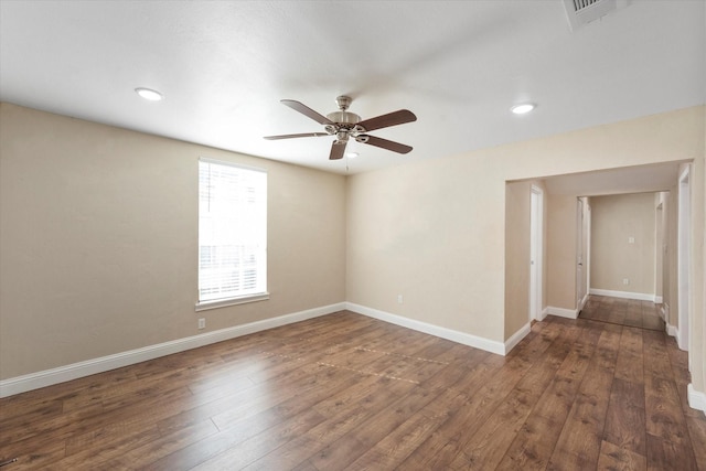 spare room featuring ceiling fan and dark hardwood / wood-style floors