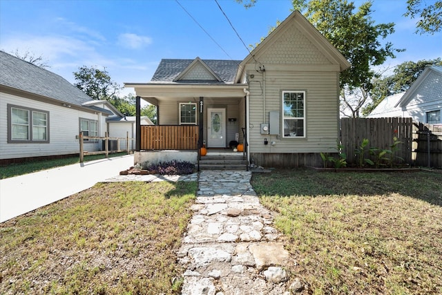 bungalow featuring a front lawn and covered porch