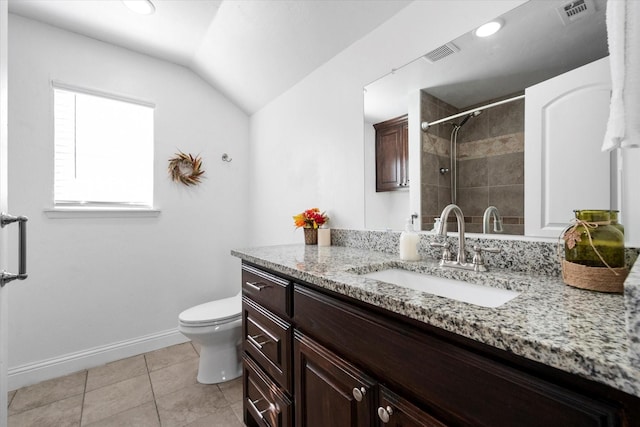 bathroom with vanity, toilet, tile patterned flooring, and vaulted ceiling