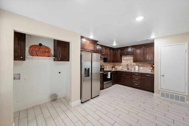 kitchen with sink, backsplash, stainless steel appliances, dark brown cabinets, and light wood-type flooring