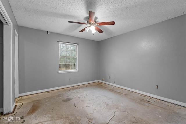 unfurnished room with ceiling fan and a textured ceiling