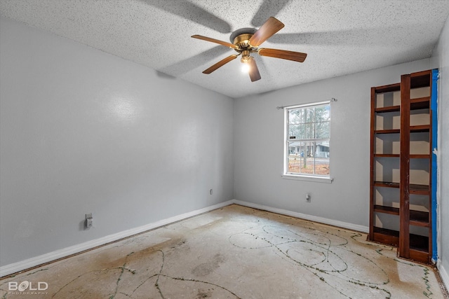 empty room featuring ceiling fan and a textured ceiling