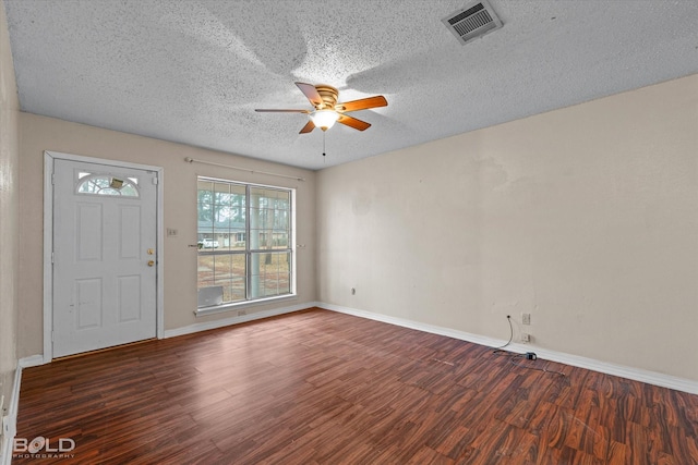 foyer with dark wood-type flooring, a textured ceiling, and ceiling fan