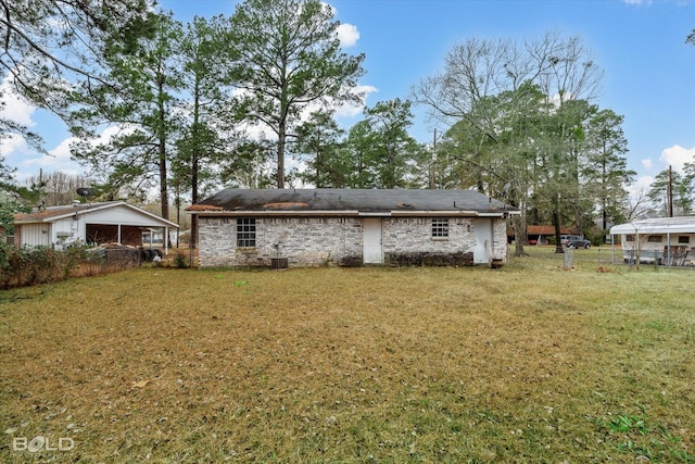 rear view of house featuring a yard