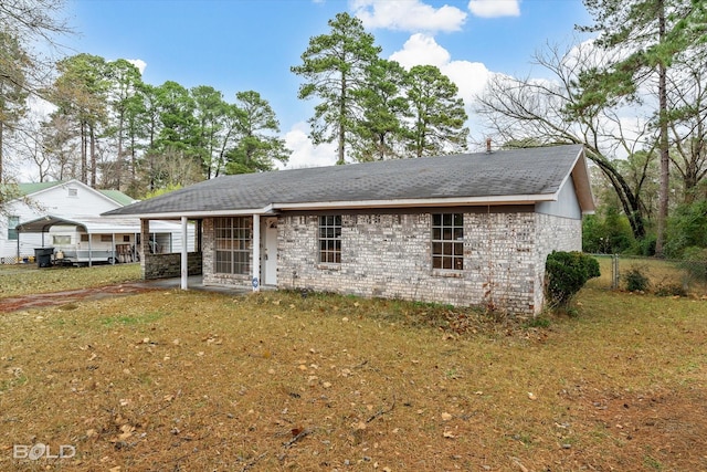 rear view of property with a yard