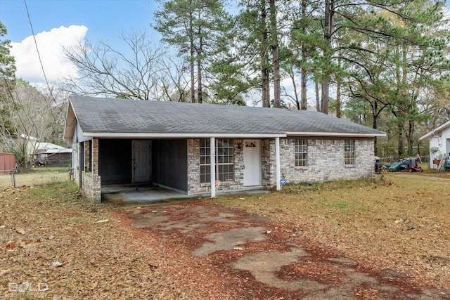 ranch-style house featuring a carport