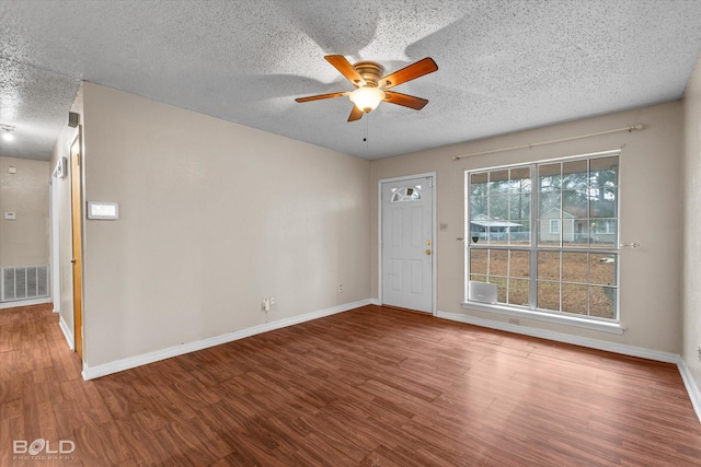 unfurnished room featuring wood-type flooring, a textured ceiling, and ceiling fan