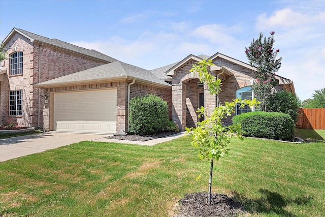 view of front of home with a garage and a front lawn