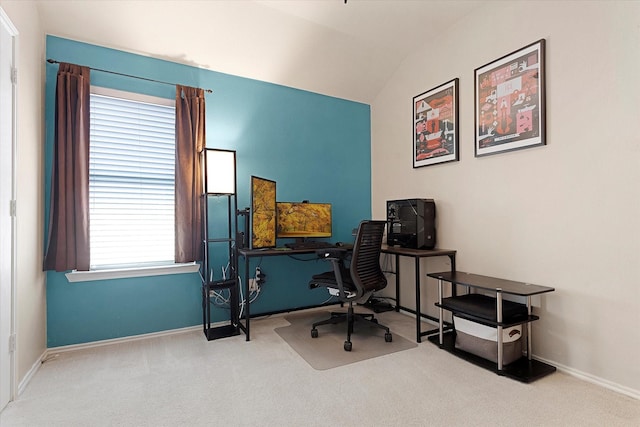 carpeted home office featuring vaulted ceiling