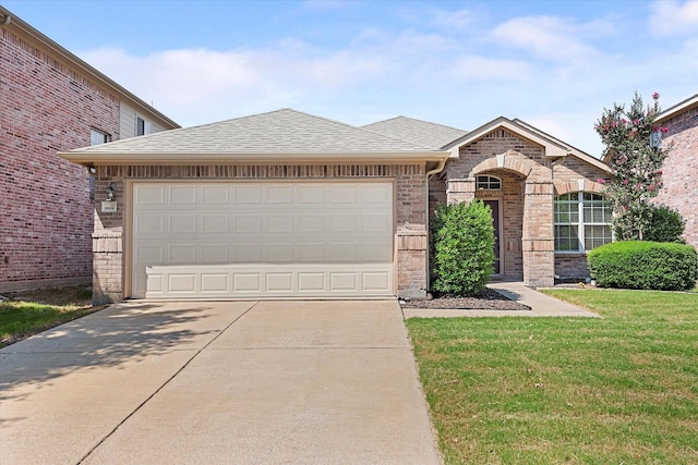 view of front of property with a garage and a front lawn