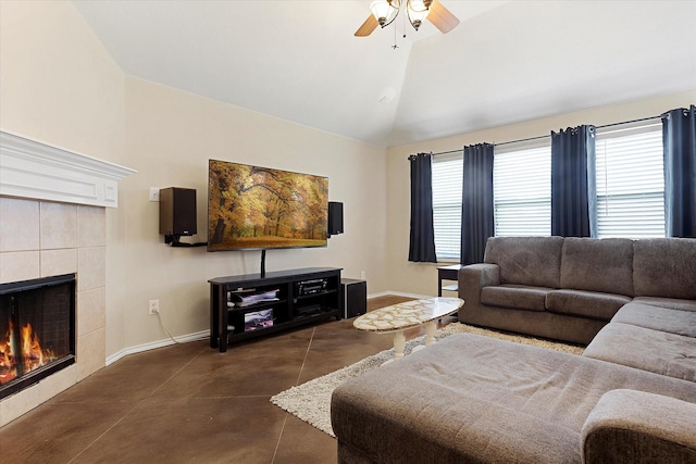 living room with ceiling fan, lofted ceiling, a fireplace, and a wealth of natural light