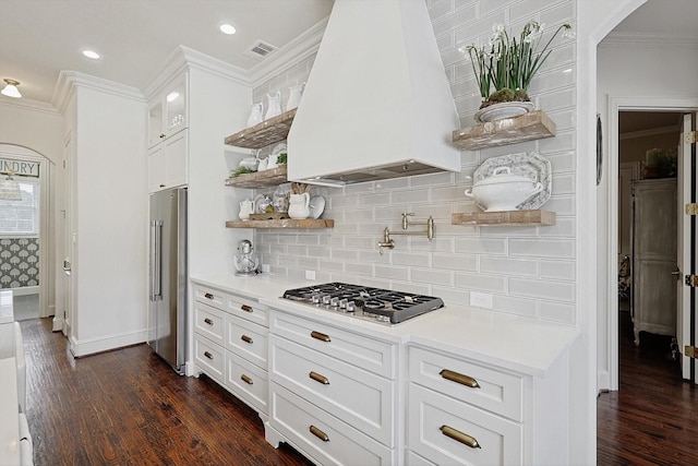 kitchen featuring custom exhaust hood, appliances with stainless steel finishes, dark wood-type flooring, and white cabinets