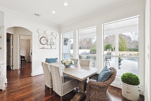 dining area featuring ornamental molding and dark hardwood / wood-style floors