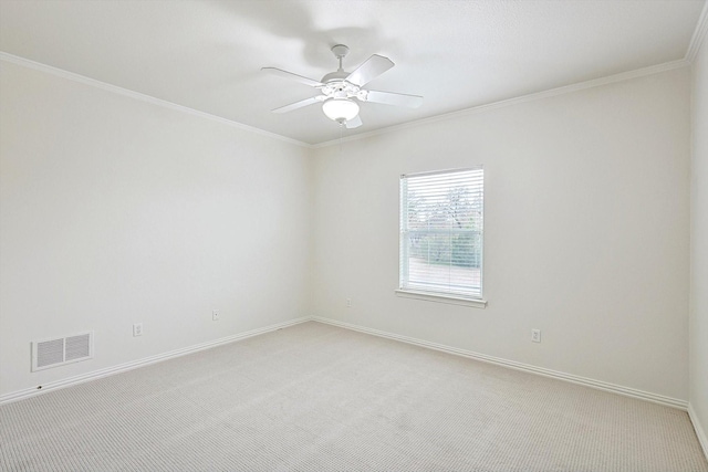 carpeted empty room featuring crown molding and ceiling fan