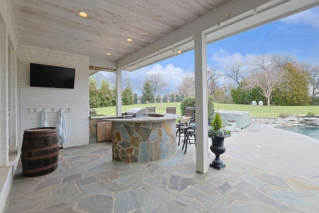 view of patio / terrace featuring an outdoor kitchen and exterior bar