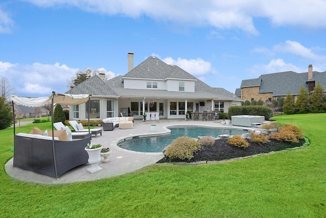 view of pool with a yard, a hot tub, an outdoor living space, and a patio area