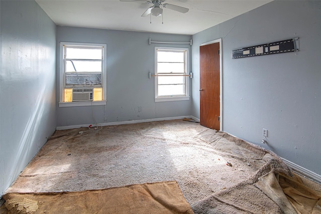 carpeted empty room featuring cooling unit and ceiling fan