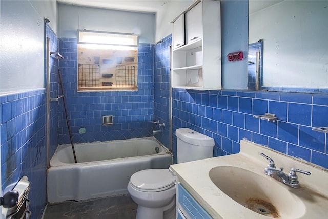 full bathroom with tiled shower / bath combo, vanity, tile walls, and toilet