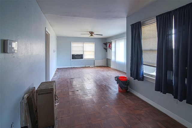 spare room featuring cooling unit, ceiling fan, and dark parquet floors