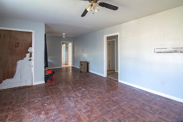 unfurnished living room with dark parquet flooring and ceiling fan