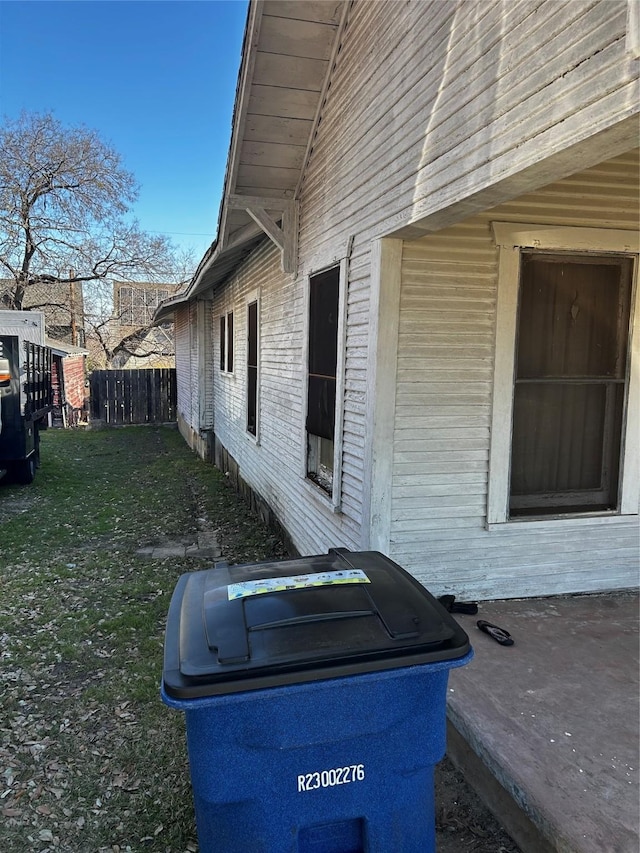 view of side of home with a lawn