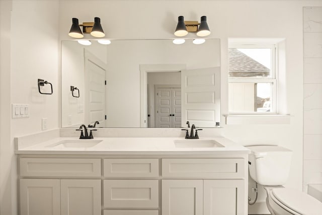 bathroom featuring vanity and toilet