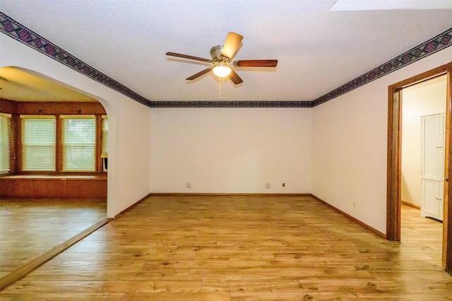 spare room featuring ceiling fan and light hardwood / wood-style flooring