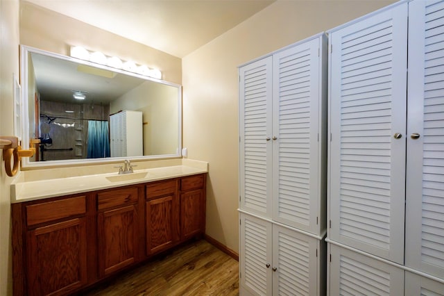 bathroom featuring vanity, hardwood / wood-style flooring, and a shower with shower curtain