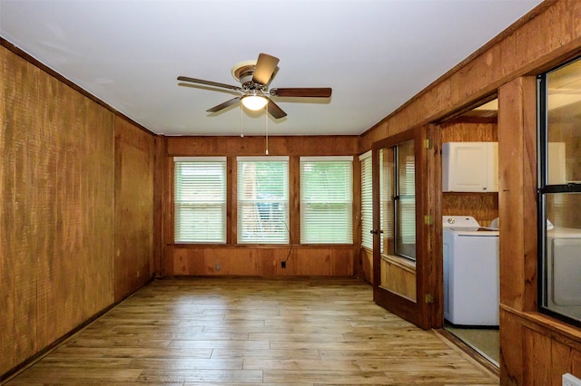 unfurnished sunroom featuring ceiling fan and washer and dryer