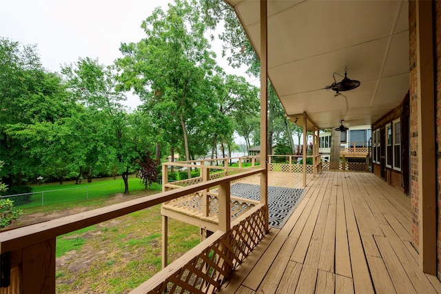 deck with ceiling fan and a yard