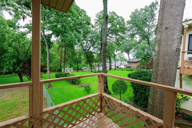 wooden terrace featuring a lawn